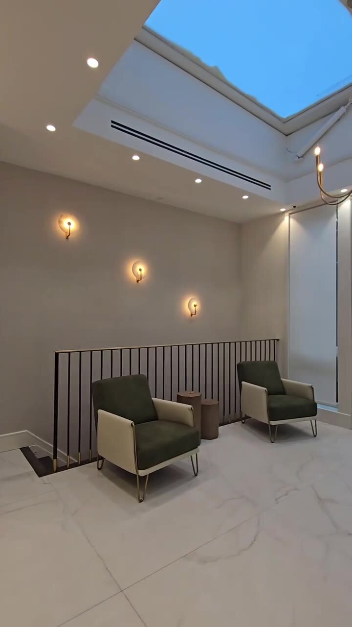 Sitting area on the upper landing beneath a large skylight